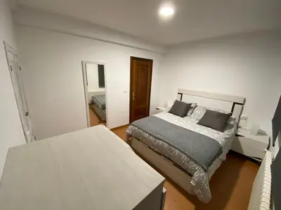 a bedroom with a bed and a mirror at Añada17 in Monforte de Lemos