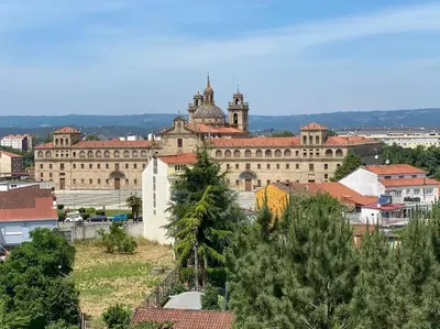 a large building with a clock tower in a city at Añada17 in Monforte de Lemos