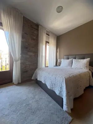 a bedroom with a large bed and a window at Airiños Aires in Santiago de Compostela