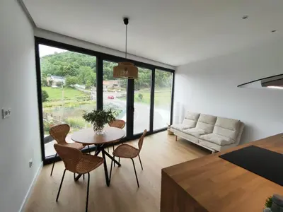 a living room with a table and chairs and a couch at Casa Tome A Teixeira - Ribeira Sacra in Teixeira
