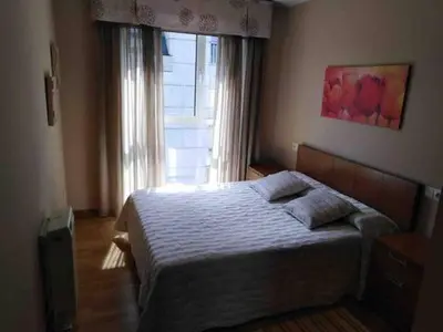 a bedroom with a bed and a window in a room at Piso en Betanzos in Betanzos