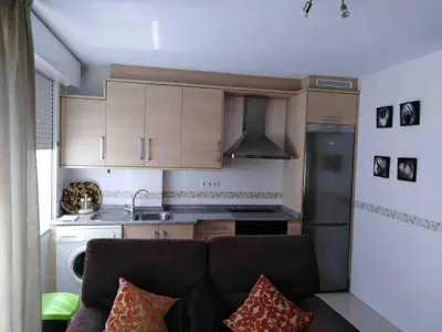 a kitchen with a couch in a small room at Piso en Betanzos in Betanzos