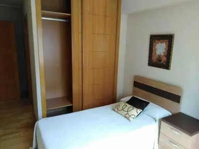 a small bedroom with a bed and a closet at Piso en Betanzos in Betanzos