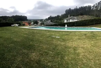 a swimming pool in the yard of a house at Piso Encanto Palmeiro in Jove