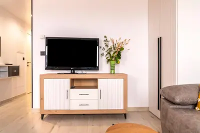 a living room with a flat screen tv on a cabinet at Maijo Burela Playa in Burela de Cabo
