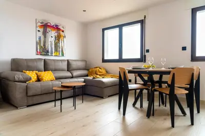 a living room with a couch and a table at Maijo Burela Playa in Burela de Cabo