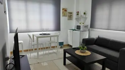 a living room with a couch and a table at LAR de Yago - Habitación Ribadeo in Ribadeo