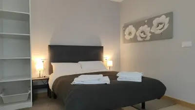 a bedroom with a bed with two towels on it at LAR de Yago - Habitación Ribadeo in Ribadeo