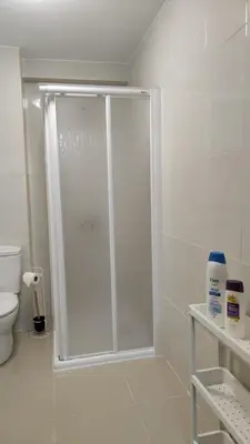 a shower with a glass door in a bathroom at LAR de Yago - Habitación Ribadeo in Ribadeo