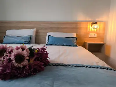 a bedroom with a bed with flowers on it at Luxury Singular Apartments Orange in Santiago de Compostela