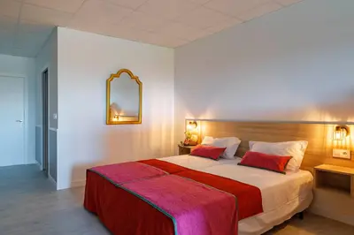 a bedroom with a large bed with a red blanket at Luxury Singular Apartments Orange in Santiago de Compostela
