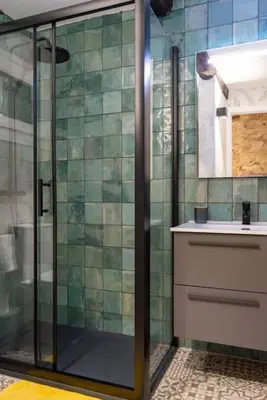 a bathroom with a glass shower and a sink at Burgas1 in Ourense