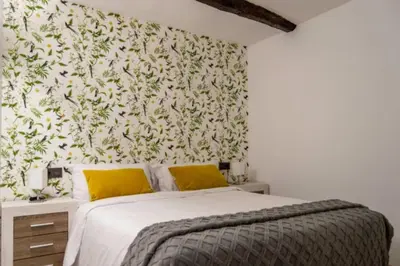 a bedroom with a bed with a floral wallpaper at Burgas1 in Ourense