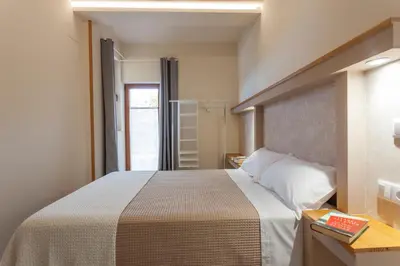 a bedroom with a large bed and a window at Apartamentos Rurales TIN TURISMO in Santa Eulalia de Oscos