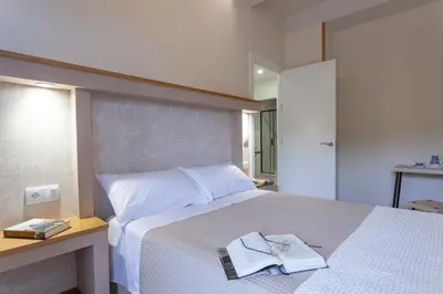 a bedroom with a bed with a book on it at Apartamentos Rurales TIN TURISMO in Santa Eulalia de Oscos