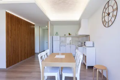 a kitchen and dining room with a table and chairs at Apartamentos Rurales TIN TURISMO in Santa Eulalia de Oscos