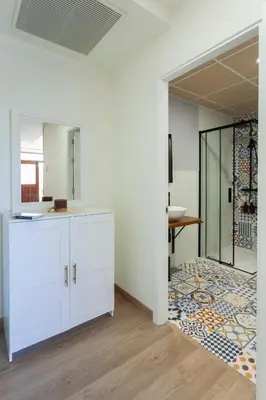 a bathroom with white cabinets and a mirror at Apartamentos Rurales TIN TURISMO in Santa Eulalia de Oscos