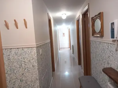 a bathroom with a hallway with a mirror and a corridor at Abrula Vilalba in Villalba