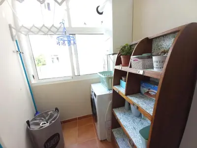 a room with a shelf with plants and a window at Abrula Vilalba in Villalba