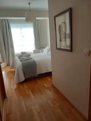a bedroom with a bed and a picture on the wall at Abrula Vilalba in Villalba
