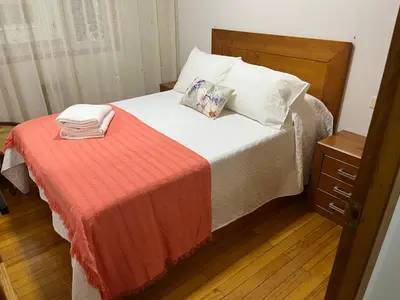 a bedroom with a bed with a red blanket at PISO ARTUR rúa astureses in Carballino