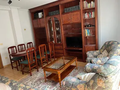 a living room with a couch and a table and chairs at PISO ARTUR rúa astureses in Carballino