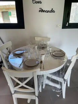 a white table with glasses and plates on it at Casa Fernanda-Ribeira Sacra in Covas