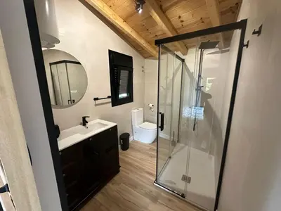 a bathroom with a shower and a sink and a toilet at Casa Fernanda-Ribeira Sacra in Covas