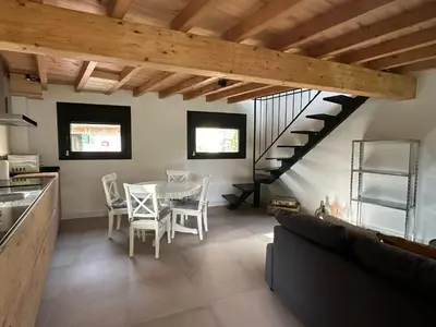 a kitchen and dining room with a table and a staircase at Casa Fernanda-Ribeira Sacra in Covas