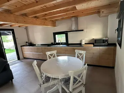 a kitchen with a table and chairs in a room at Casa Fernanda-Ribeira Sacra in Covas