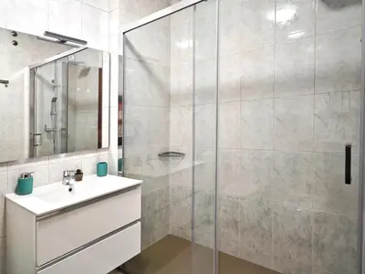 a bathroom with a sink and a shower at Piso céntrico Santiago de Compostela con terraza y parking in Santiago de Compostela