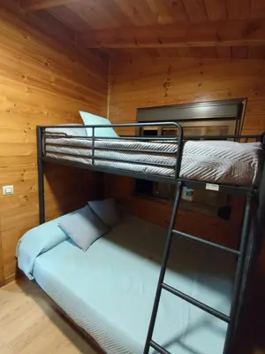 a bedroom with two bunk beds in a cabin at Lar de Pazos in Padrón