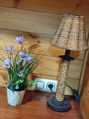 a lamp and a vase of flowers on a table at Lar de Pazos in Padrón