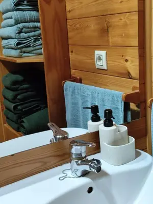 a bathroom with a sink with a mirror and a sink at Lar de Pazos in Padrón
