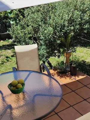a glass table with a bowl of fruit on a patio at Lar de Pazos in Padrón