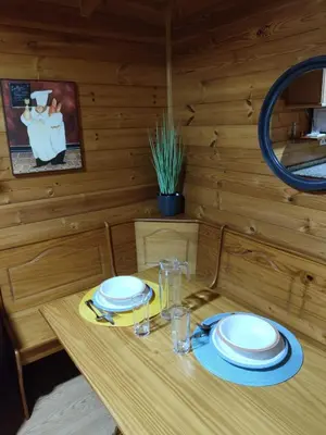 a wooden table with plates and glasses on it at Lar de Pazos in Padrón