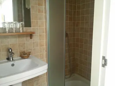 a bathroom with a sink and a shower at Pensión con Encanto San Martiño Pinario in Santiago de Compostela