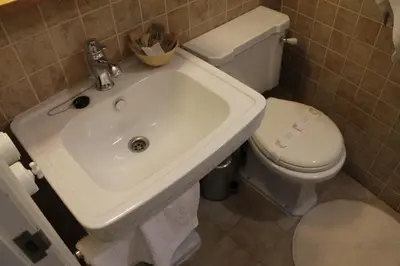 a bathroom with a white sink and a toilet at Pensión con Encanto San Martiño Pinario in Santiago de Compostela