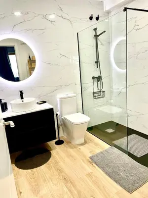 a bathroom with a toilet and a sink and a shower at Alojamiento D'Moda in Ribadeo