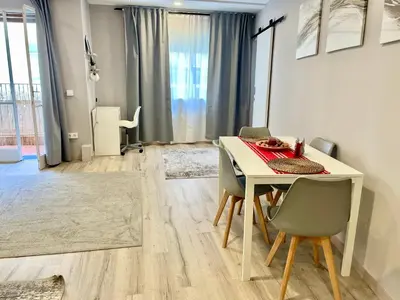 a dining room with a white table and chairs at Alojamiento D'Moda in Ribadeo