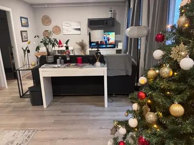 a living room with a christmas tree and a desk at Alojamiento D'Moda in Ribadeo