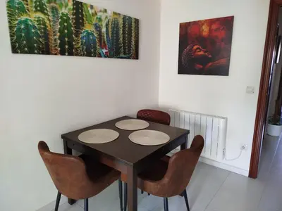 a dining room with a black table and chairs at Apartamento Xaquina in Melide