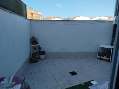 a room with a white tiled floor and a white wall at Apartamento Xaquina in Melide