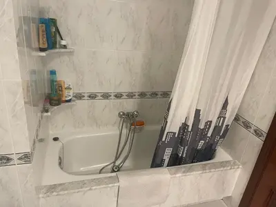a bath tub with a shower curtain in a bathroom at Apartamento Xaquina in Melide