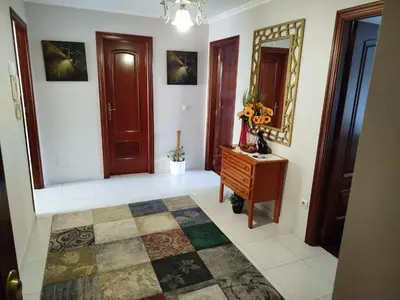 a hallway with a dresser and a mirror at Apartamento Xaquina in Melide