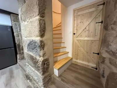 a hallway with a barn door and a staircase at Casa de Lucinda-Ribeira Sacra in Covas