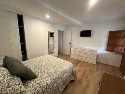 a bedroom with a bed and a tv on the wall at Casa de Lucinda-Ribeira Sacra in Covas