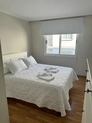 a bedroom with a white bed with a window at Serendipia in Villalba