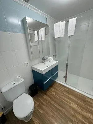 a bathroom with a toilet and a sink and a shower at Serendipia in Villalba