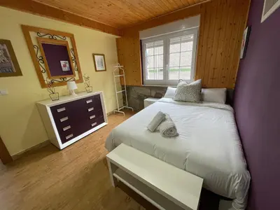 a bedroom with a white bed and a window at Apartamento La Veiga in Cerredo